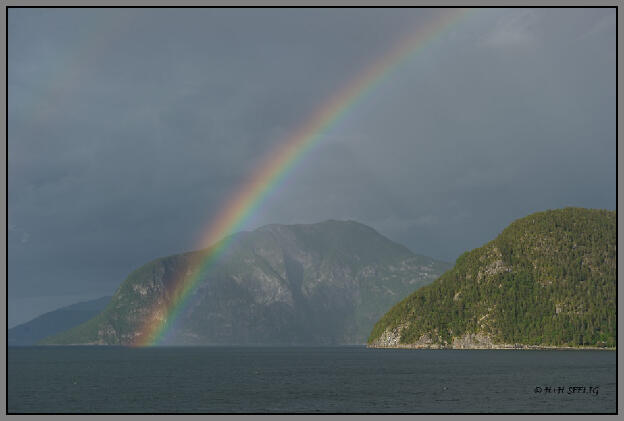 Regenbogen über dem Fjord